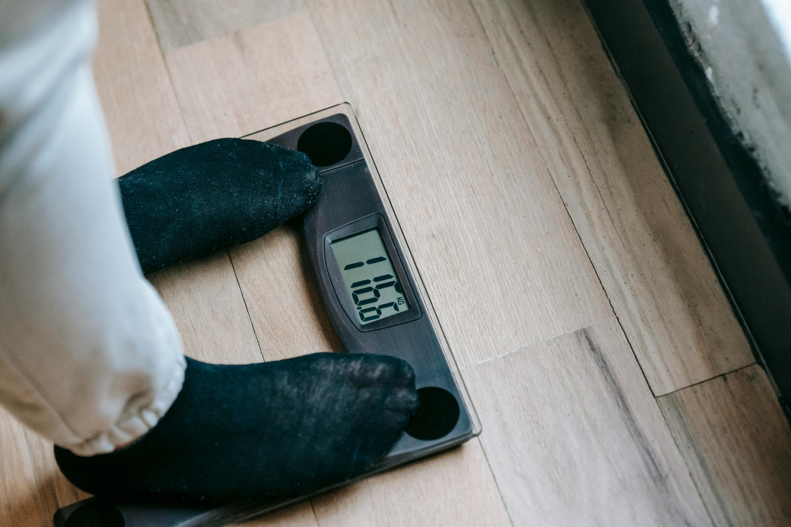Person standing on a scale to measure weight loss