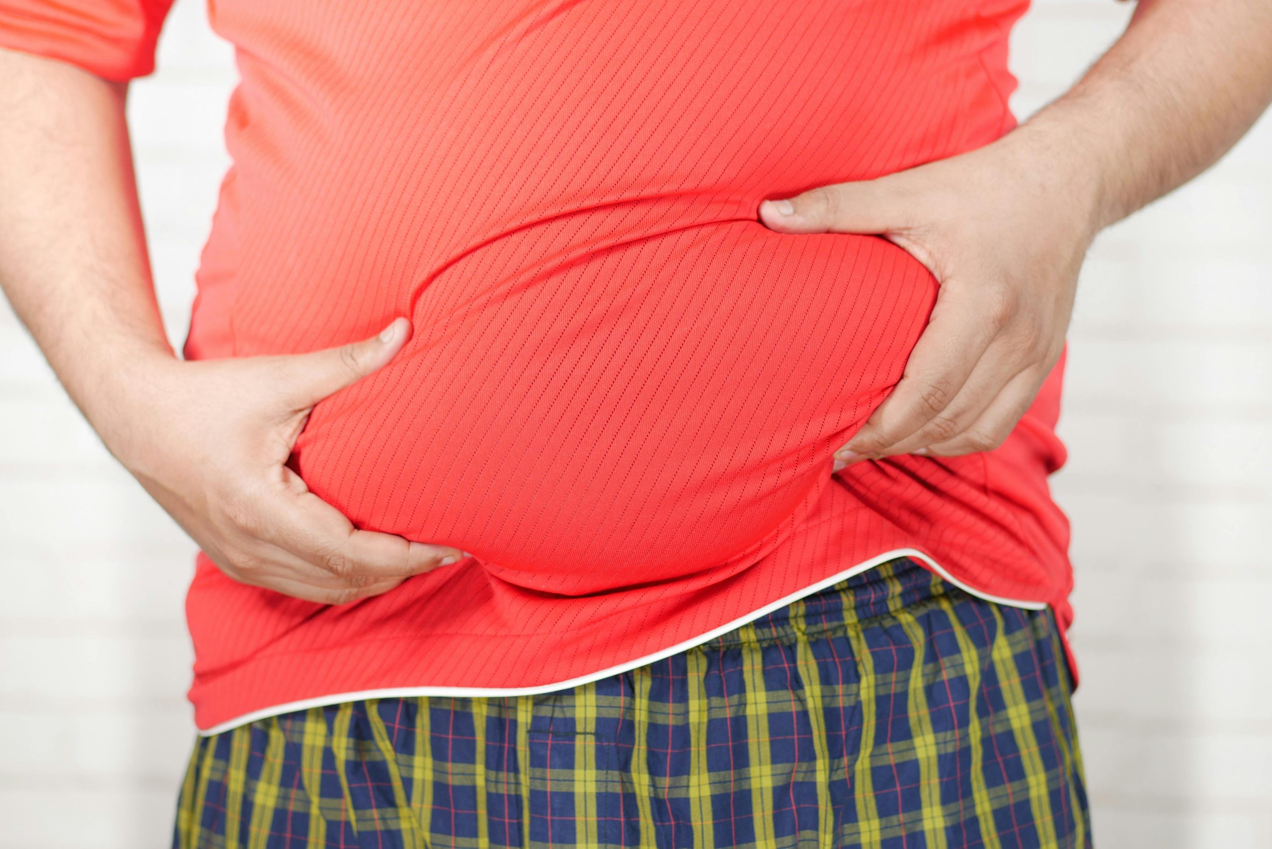 Overweight man holding his stomach